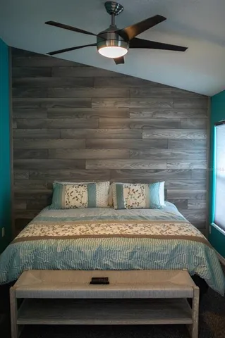 a bedroom with a bed and ceiling fan