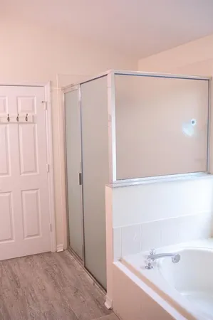 a bathroom with a bathtub and a shower