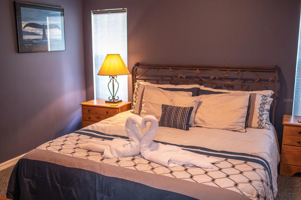 2577 Oneida Loop Kissimmee, FL 34747 - Photo 20 of 36 a bedroom with a bed and a lamp on dresser