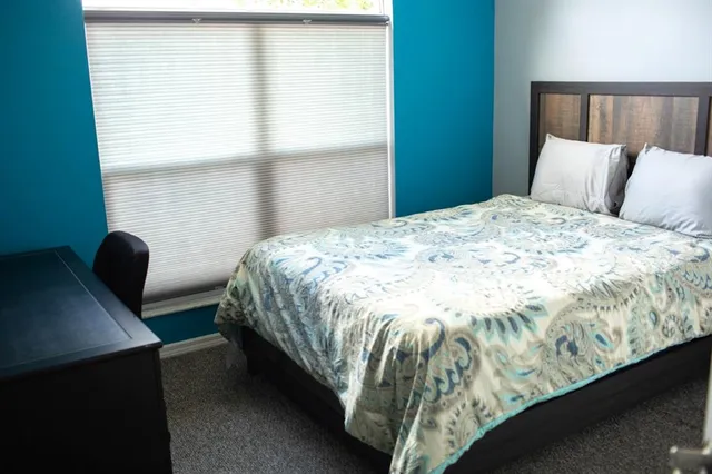 a bedroom with bed and window