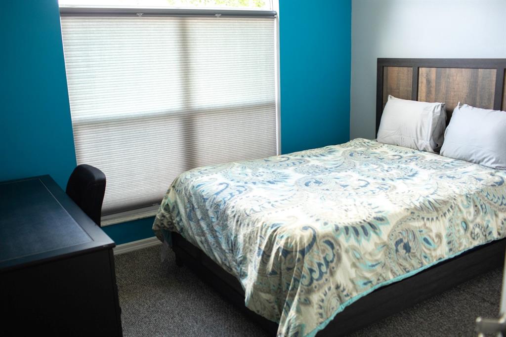 2577 Oneida Loop Kissimmee, FL 34747 - Photo 24 of 36 a bedroom with bed and window