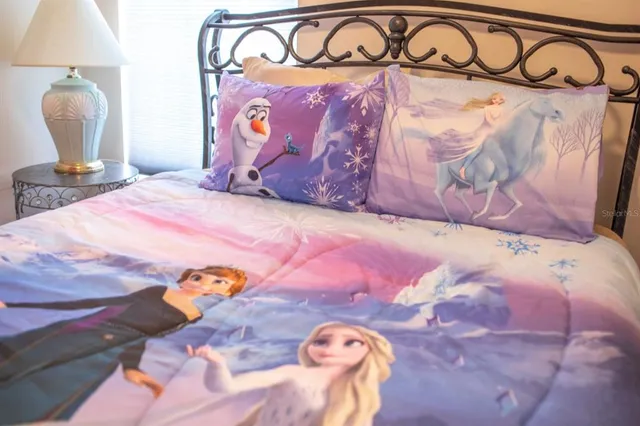 a bedroom with a bed and a painting on the wall