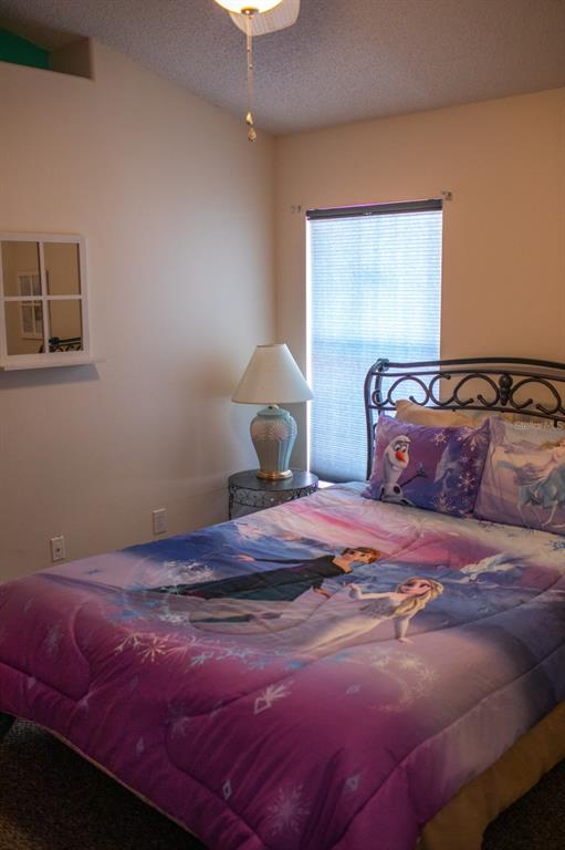 2577 Oneida Loop Kissimmee, FL 34747 - Photo 26 of 36 a bedroom with a bed and a window