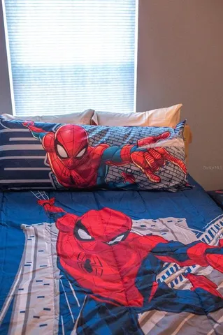 a bedroom with a bed and a lamp