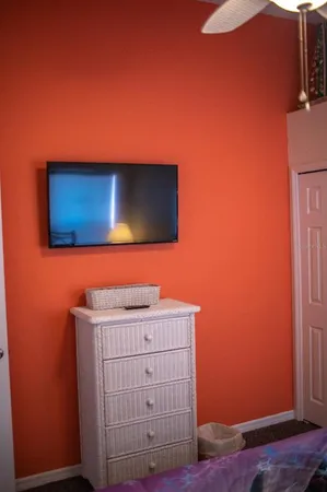 a white toilet sitting next to a white curtain