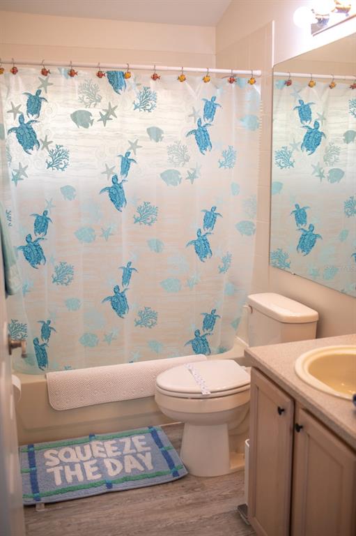 2577 Oneida Loop Kissimmee, FL 34747 - Photo 33 of 36 a white toilet sitting next to a white curtain