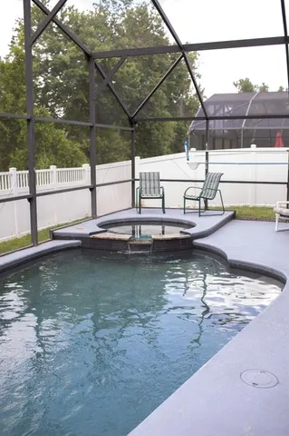 a swimming pool with outdoor seating