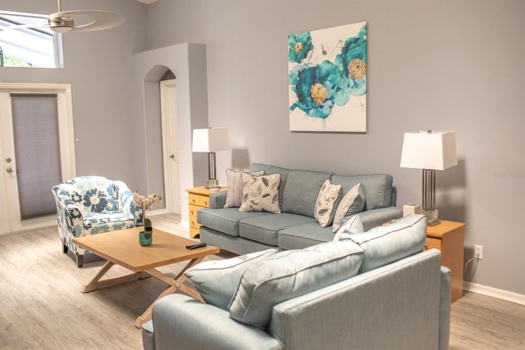 2577 Oneida Loop Kissimmee, FL 34747 - Photo 5 of 36 a living room with furniture and a painting on the wall