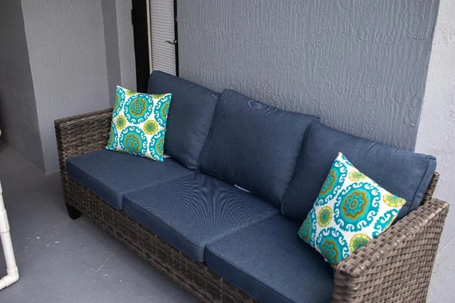 a wooden bench sitting in front of a building