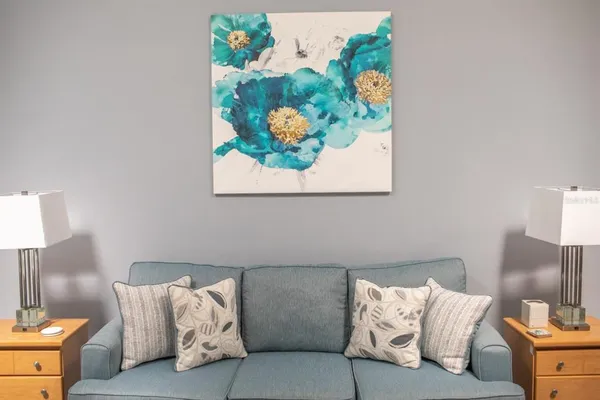 a living room with furniture and a lamp