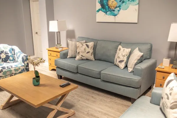 a living room with furniture and a lamp