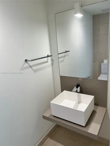 a kitchen with stainless steel appliances a sink a stove and a wooden floors