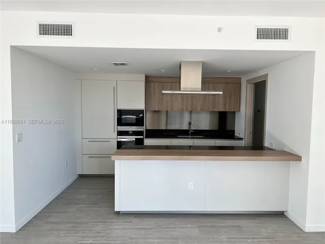 a bathroom with a granite countertop shower a toilet and a sink