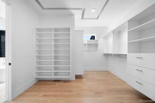 a view of walk in closet with empty racks