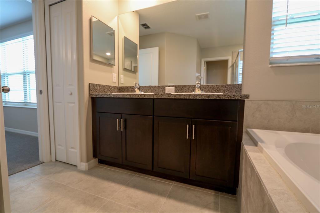 4714 Norman Oak Place Tampa, FL 33619 - Photo 12 of 32 a bathroom with a sink and a bathtub