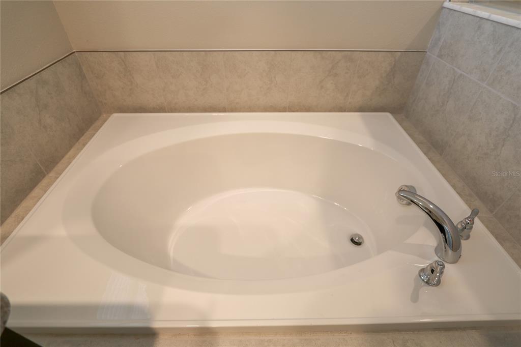 4714 Norman Oak Place Tampa, FL 33619 - Photo 13 of 32 a white bath tub sitting in a bathroom
