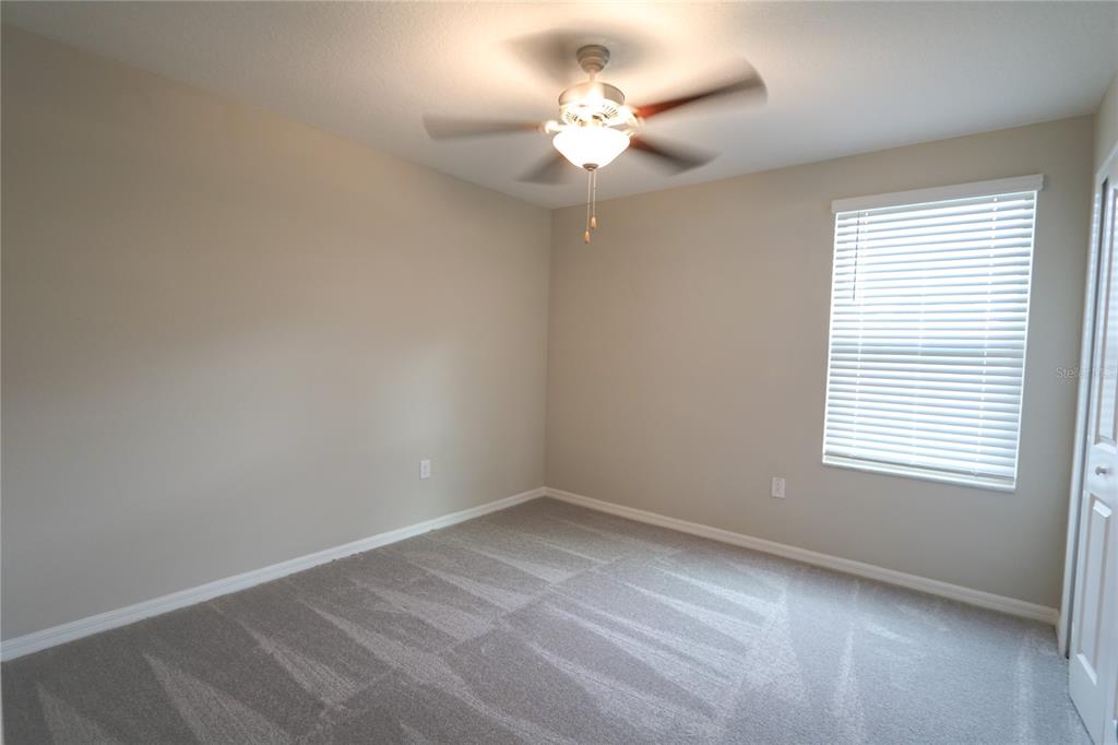 4714 Norman Oak Place Tampa, FL 33619 - Photo 14 of 32 wooden floor in an empty room with a window