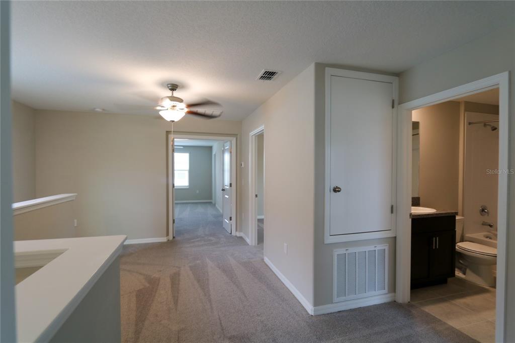 4714 Norman Oak Place Tampa, FL 33619 - Photo 15 of 32 a view of a hallway with a chandelier