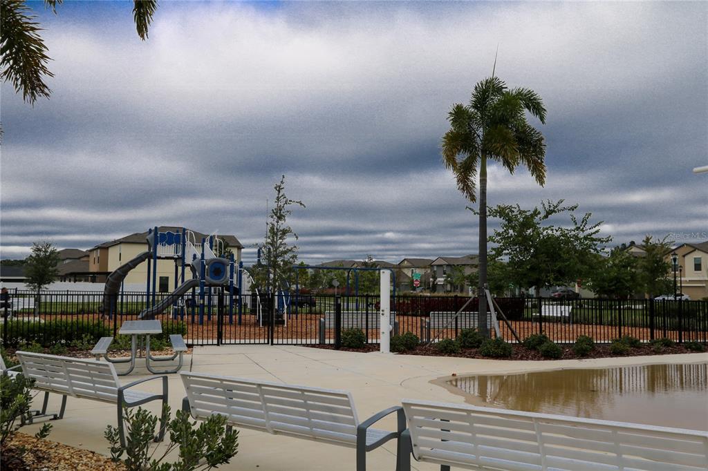 4714 Norman Oak Place Tampa, FL 33619 - Photo 25 of 32 a view of a swimming pool with a chair and tables