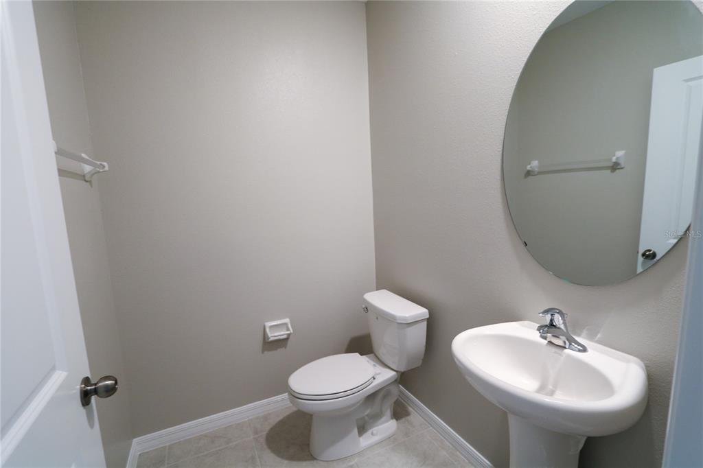 4714 Norman Oak Place Tampa, FL 33619 - Photo 7 of 32 a bathroom with a sink toilet and mirror