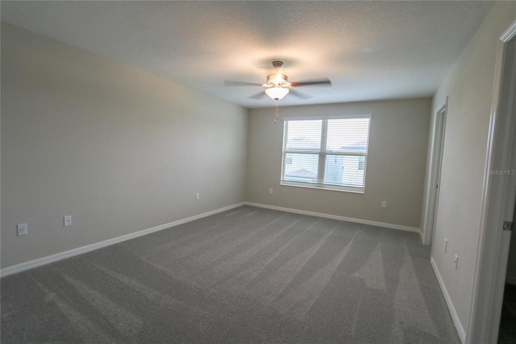 4714 Norman Oak Place Tampa, FL 33619 - Photo 9 of 32 wooden floor in an empty room with a window