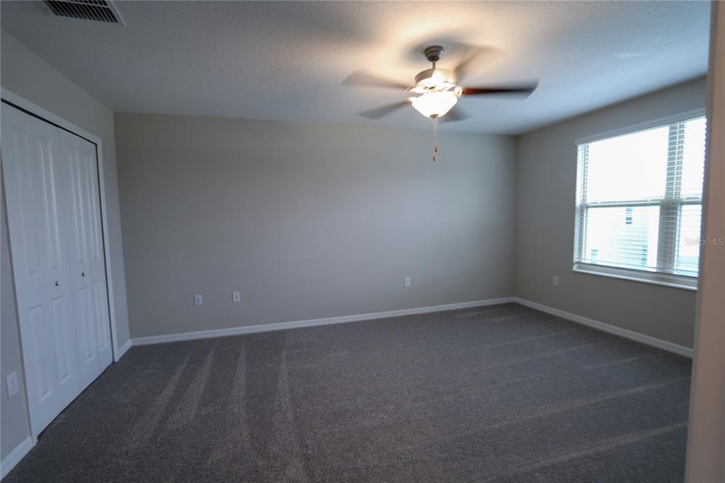 4714 Norman Oak Place Tampa, FL 33619 - Photo 10 of 32 wooden floor in an empty room with a window