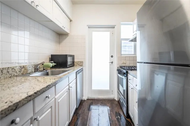 a kitchen with a refrigerator a sink and a stove