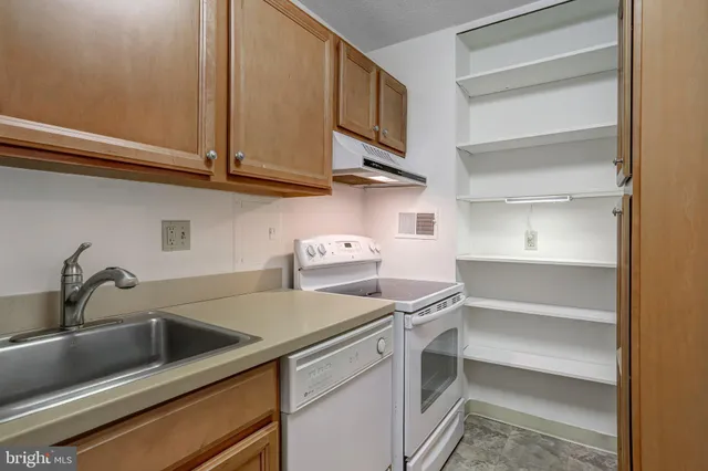 a view of a kitchen with sink and cabinets