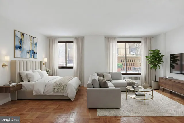 a bedroom with furniture and a large window