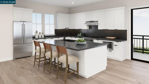 a kitchen with a refrigerator and a stove top oven