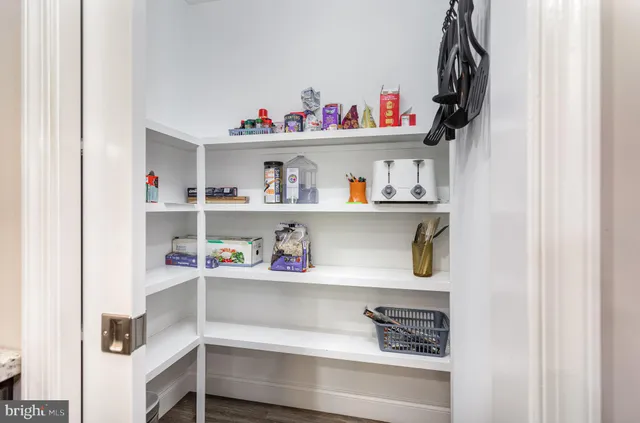 a kitchen with stainless steel appliances granite countertop a stove top oven a sink dishwasher a dining table and chairs with wooden floor