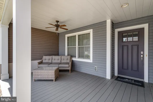 a living room with furniture and two window