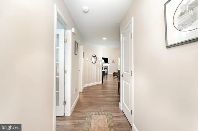 a view of a hallway with wooden floor