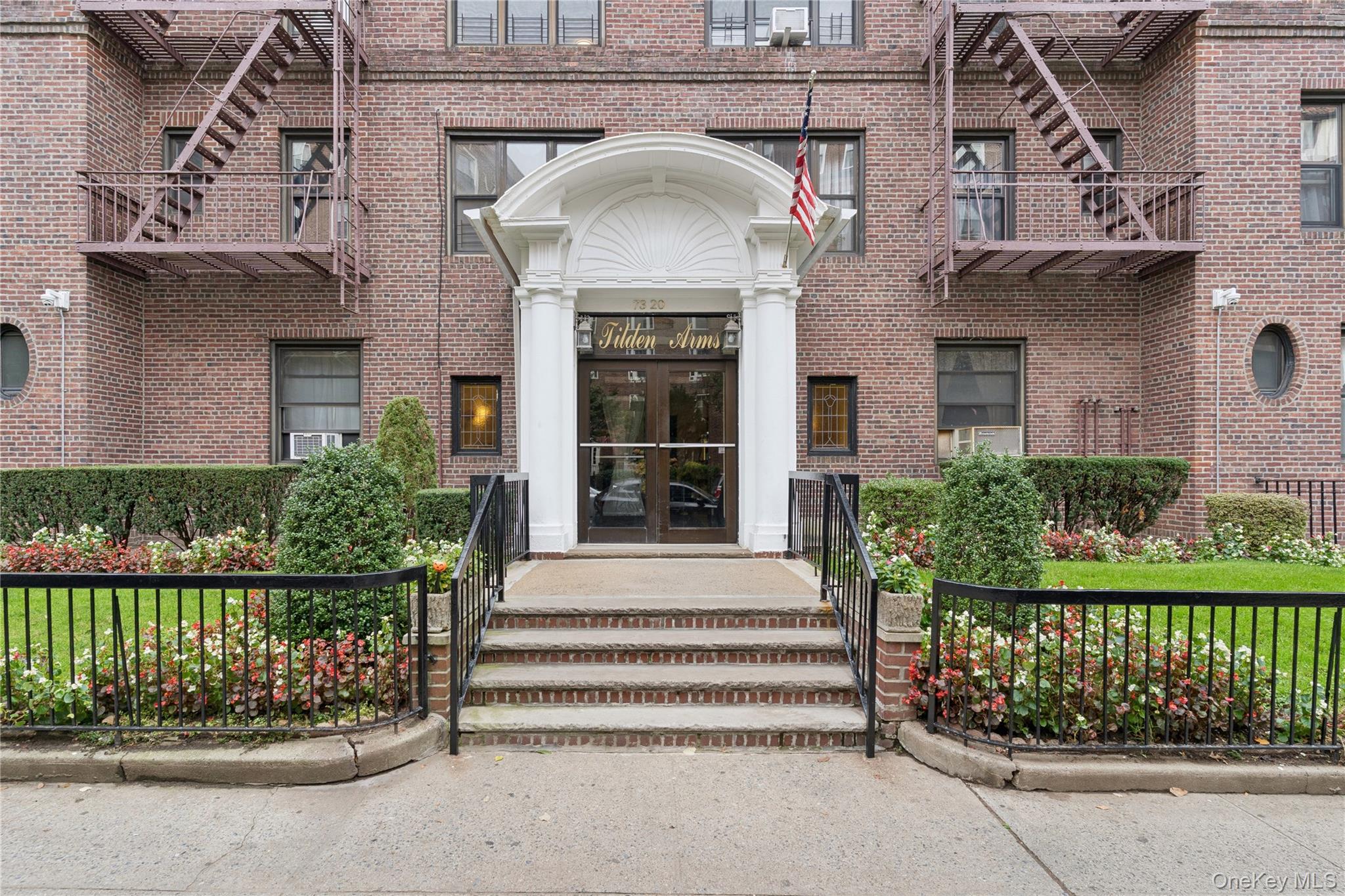a view of a entrance gate of a house with a garden