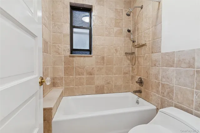 a bathroom with a bathtub and window