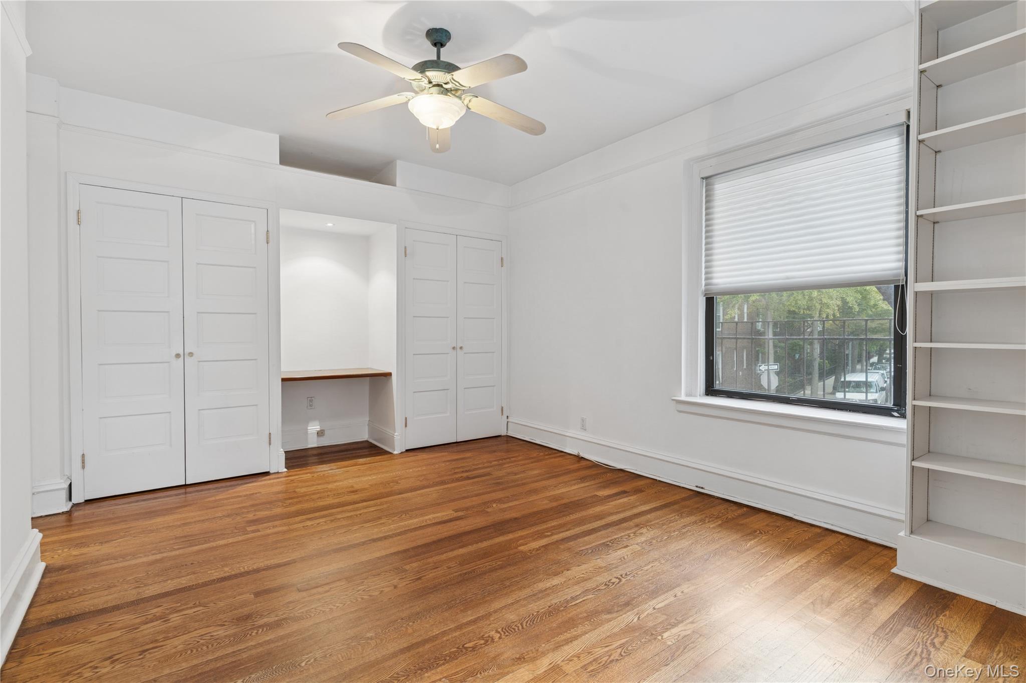 73-20 Austin Street, Unit 2E Queens, NY 11375 - Photo 9 of 13 a view of empty room with wooden floor and fan
