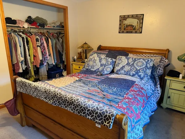 a bed sitting in a bedroom next to a bedroom