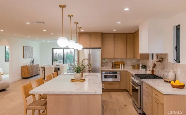 a kitchen with counter space appliances and a view of living room