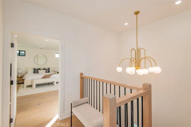 a spacious bedroom with a bed and a lamp