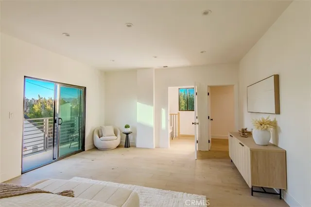 a bedroom with a bed and a painting on the wall