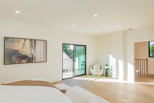 a bedroom with a bed and a mirror