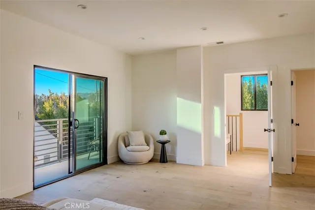 a spacious bathroom with a double vanity sink toilet mirror and shower