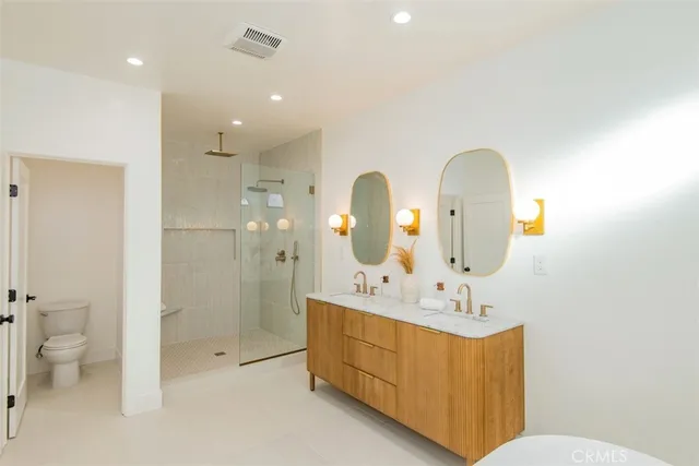 a bathroom with a double vanity sink and a mirror