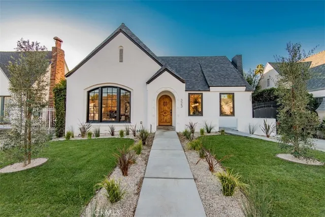 a front view of a house with garden