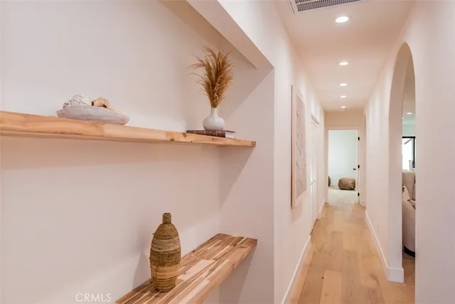 a view of a room with furniture and wooden floor