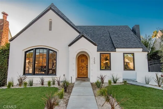 a front view of a house with a garden