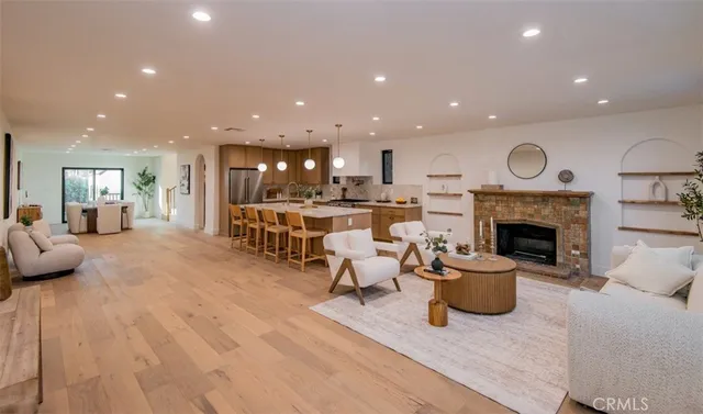 a living room with furniture wooden floor and a fireplace