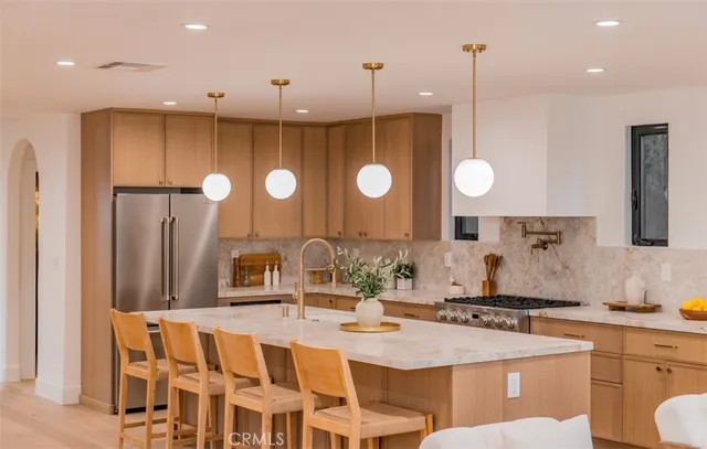 a large kitchen with a table and chairs