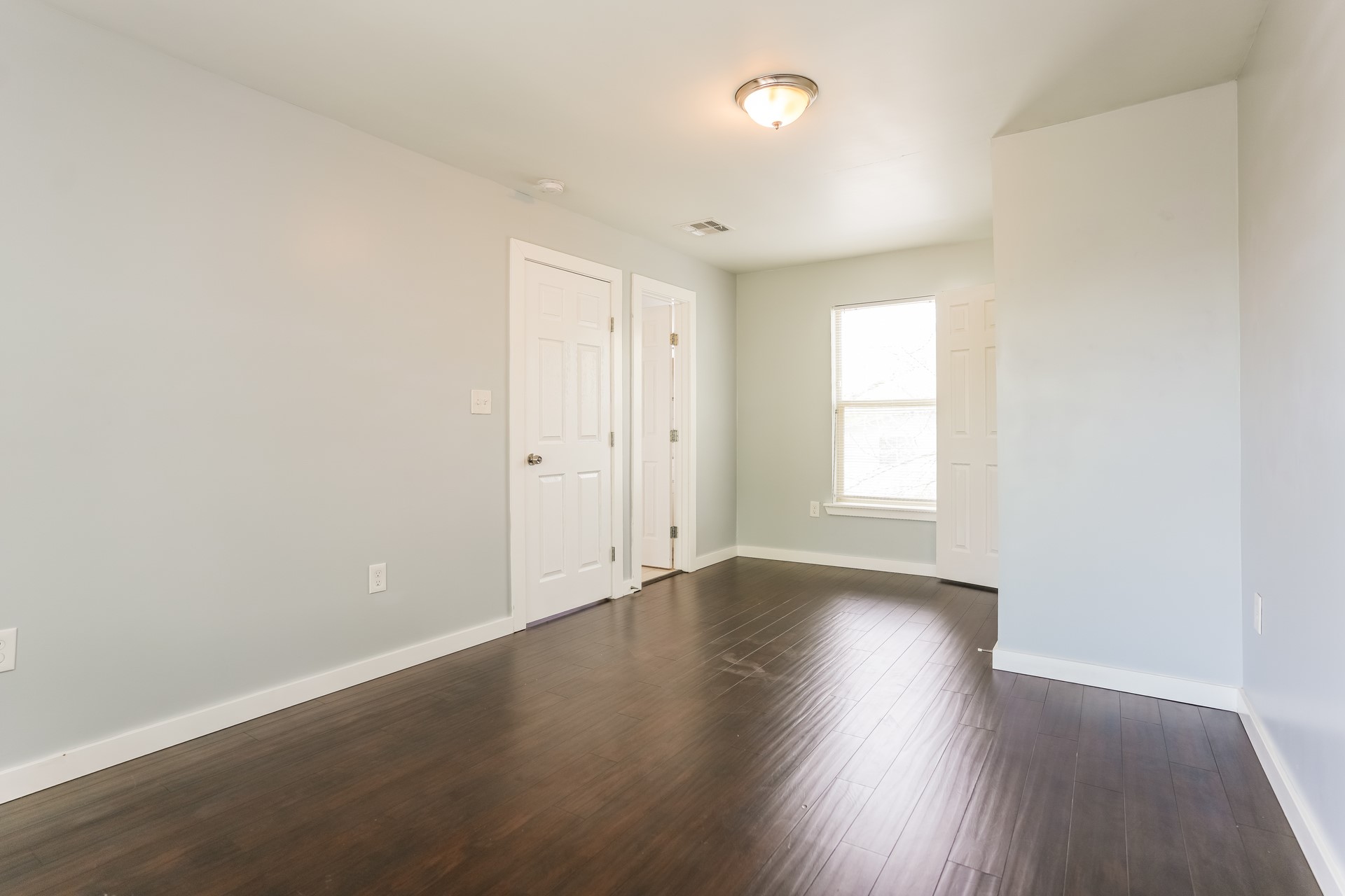 4801 Avenue H Austin, TX 78751 - Photo 12 of 16 Spare room with baseboards and dark wood-type flooring