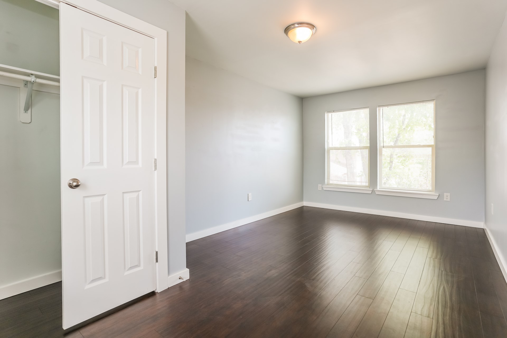 4801 Avenue H Austin, TX 78751 - Photo 5 of 16 Unfurnished bedroom featuring dark wood-type flooring and a closet
